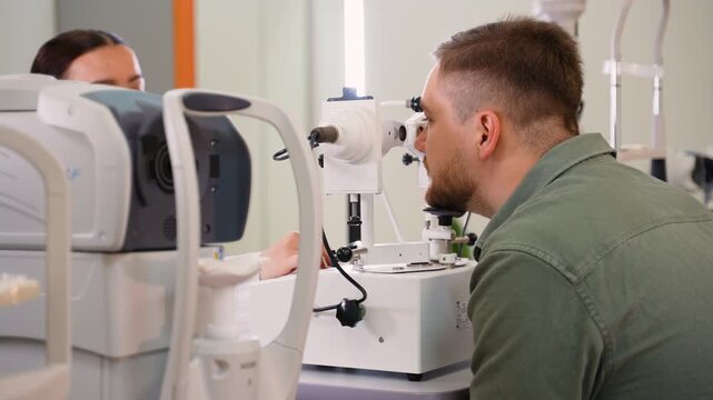 Male patient undergoing eye examination with slit lamp