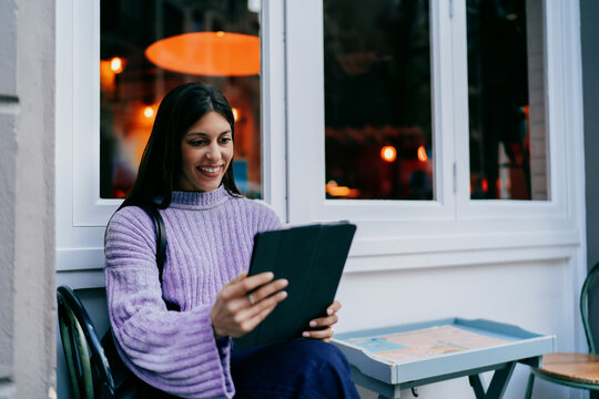 Close up of smiling woman looking at tablet screen. Digital banking, mobile payment, online shopping or social media interaction. Tech savvy user enjoying high speed internet connection, 5G web.
