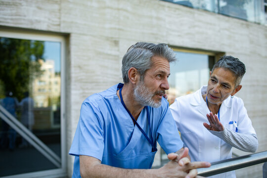 Senior medical professionals discussing outside hospital