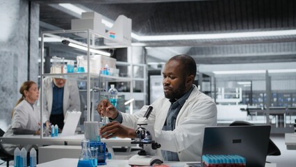 Lab assay development specialist investigating blue liquid polymer properties in test tube...