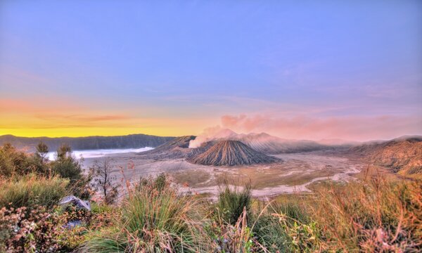 Sunrise, smoking Mount Bromo, Mt. Batok at front, Mt. Kursi at back, Mt. Gunung Semeru, Bromo Tengger Semeru National Park, Java, Indonesia