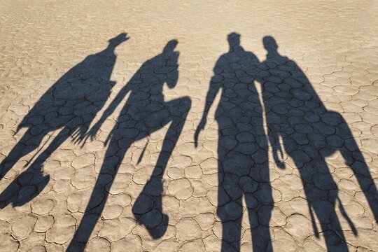 The shadows of people on dry salt pan, Dead Pan, Sossusvlei, Namib Desert, Namibia