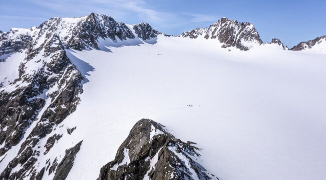 Aerial view of a group of alpinists in the high mountains with the glacier Lisener Ferner, Brunnenkogel and L&uuml;sener Spitze in the background, mountains in winter, Stubai Alps, Tyrol, Austria
