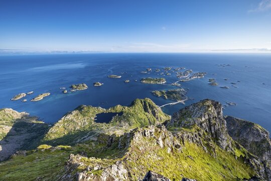 View of fishing village Henningsvaer from the top of Festv&aring;gtinden, Small islands connected by road and bridges, Austv&aring;g&oslash;ya, Lofoten, Norway