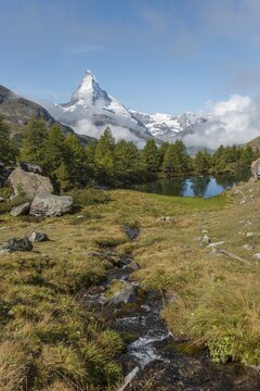 Snow-covered Matterhorn, stream flows into the Grindijsee, Valais, Switzerland