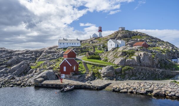 Houses and red and white Lindesnes lighthouse, Lindesnes, Norway