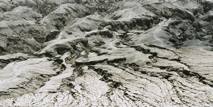 Hostile volcanic landscape, gaps and cracks, dry ground on volcano crater, Mount Bromo, Bromo Tengger Semeru National Park, Java, Indonesia