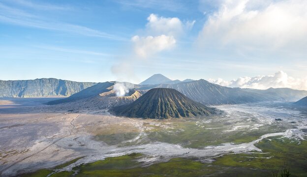 Volcanic landscape at sunrise, smoking volcano Gunung Bromo, with Mt. Batok, Mt. Kursi, Mt. Gunung Semeru, Bromo-Tengger-Semeru National Park, Java, Indonesia