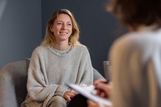 Young woman in therapy session with therapist in calm modern office