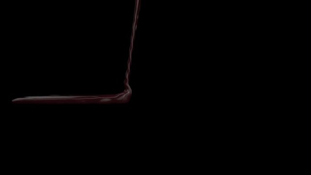 a stream of liquid chocolate pouring down on a flat surface
