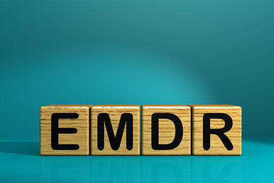 Eye Movement Desensitization and Reprocessing, EMDR concept with the word on wooden block.