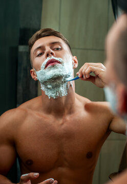 Man Shaving Beard in Bathroom.