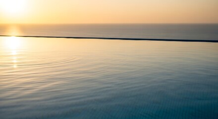 Fototapeta premium Ocean sunrise with smooth ripple reflections and horizon light streaks for travel, branding backgrounds, and inspirational marketing design