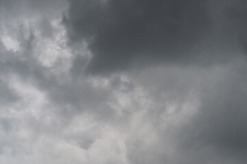 Obraz premium Menacing storm clouds approach horizon. Threatening dark clouds drift swiftly across distant sky. Foreboding storm clouds swirl with intensity as weather rapidly darkens