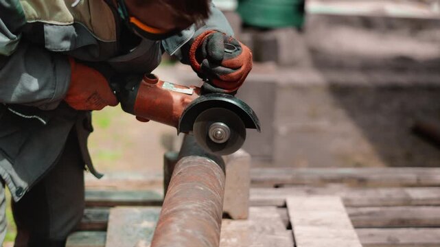 Craftsman uses angle grinder to restore rusted pipe near country house workshop. Warm sparks and detailed closeup create atmosphere of productive home improvement and practical outdoor labor.