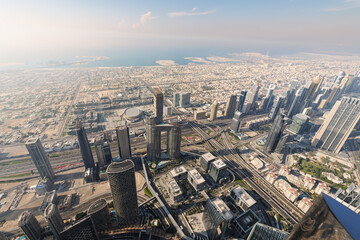 Fototapeta premium Downtown and Persian gulf views from the open air observation deck at the top of the Burj Khalifa skyscraper, Dubai United Arab Emirates.