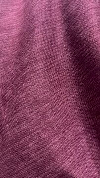 Pink silk fabric texture moving in soft waves close up background