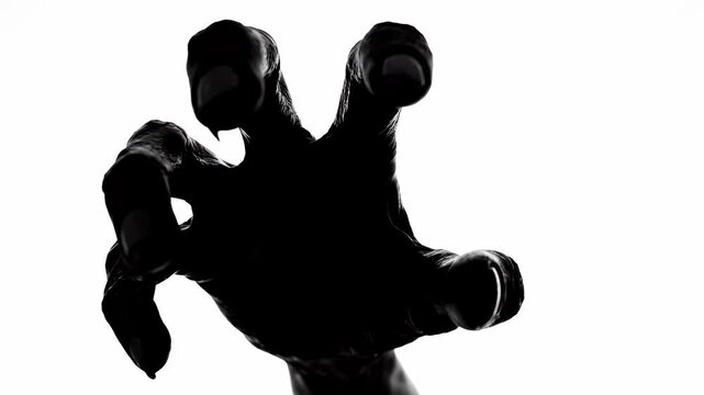 Silhouetted Zombie Hands Reaching Out on White