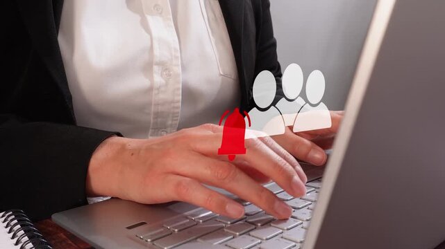 Close-up of a professional woman interacting with her computer, featuring an animated group icon with a notification bell. Group notifications.