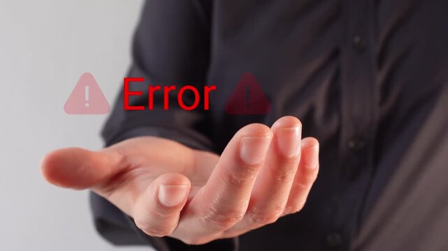 Close-up of a businesswoman's hand holding an "Error" animation with warning signs. Warning message of a computer error.