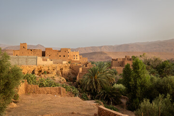 Fototapeta premium Ancient Berber kasbahs made of red clay and prickly pears in Dades Valley, Morocco.