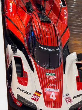 BELO HORIZONTE, MG, BRAZIL, MAY, 10, 2026 A detailed view of a red and white Porsche race car model with sponsor logos