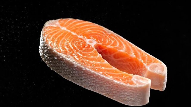 Fresh Salmon Steak with Water Droplets on Black Background