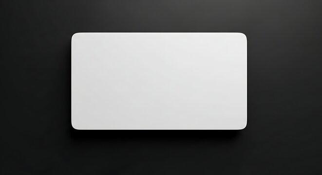 Isolated empty white rectangular fridge magnet with rounded corners on dark background, blank space for custom branding