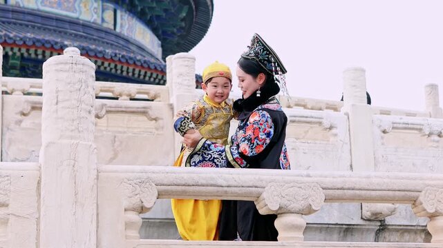 Chinese mother and son in traditional clothes at the Temple of Heaven in Beijing