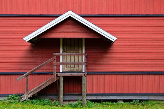 Back door entrance of an old red painted building