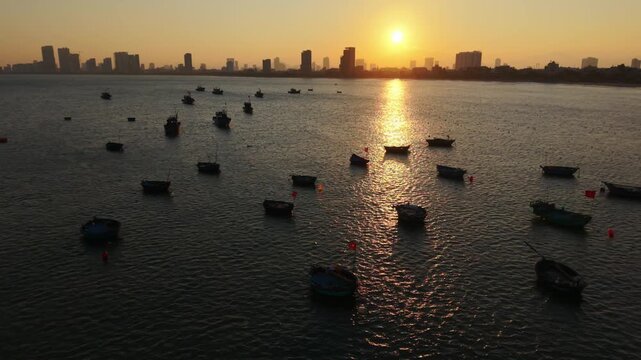 Vietnam, Da Nang Da Nang Basket Boats At Dusk, Warm Sunset Glow On Textured Water With Scattered Round Boats And Gentle Ripples, Distant Skyline Framing Maritime Heritage Scene Ideal
