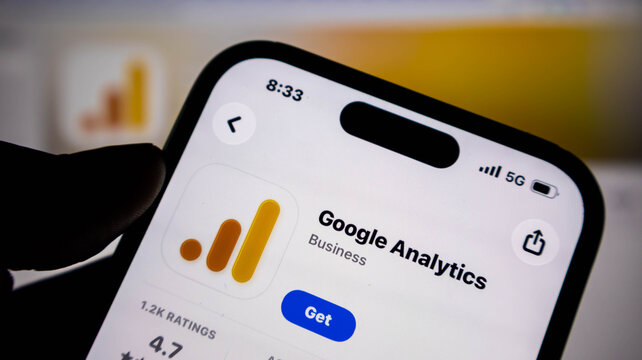 Closeup of a smartphone screen displaying the google analytics app store page, showing the application icon, rating, and download button