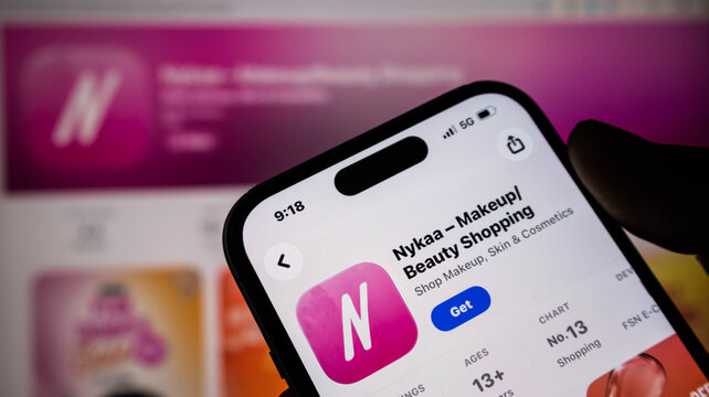Closeup of a smartphone screen displaying the nykaa makeup and beauty shopping application on the apple app store