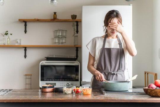 A housewife struggling to prepare lunch in the kitchen