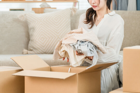 Young women who pack their belongings for a move, declutter, rent, subscribe to services, shop online, and use flea market apps at home.