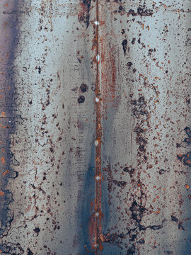 Rusted Industrial Metal Sheet with Vertical Seam and Gritty Texture