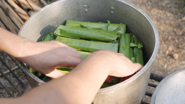 Steaming Wrapped Cassava Suman in Traditional Filipino Cooking