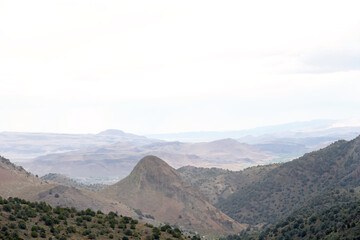 Fototapeta premium Panoramic landscape of mountains along the Nevada California border. Hazy clouds in sky
