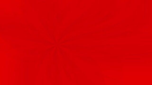 Abstract red background with a rotating spiral starburst pattern for video backdrop