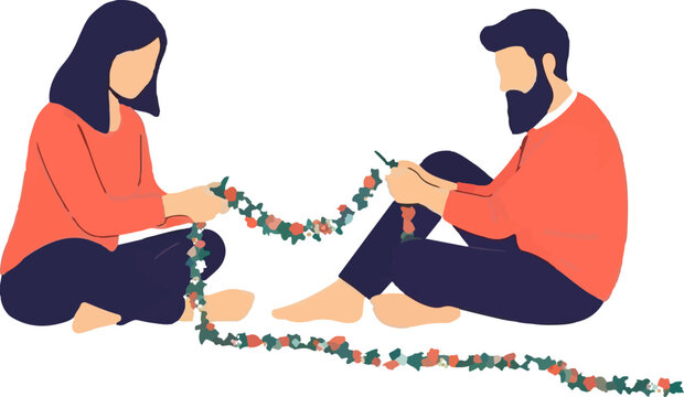 Couple sitting on floor with garland.