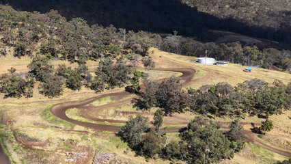 Obraz premium Aerial View of Winding Dirt Track in Australian Bushland