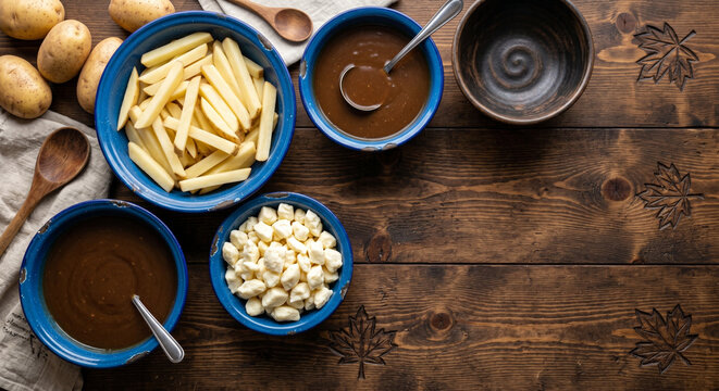 Top down flat lay of Poutine ingredients on carved maple leaf pine, bottom right copy space