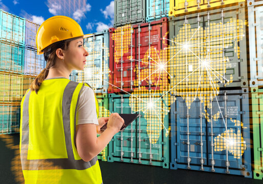 Logistics manager monitors global cargo flows with tablet at container terminal.