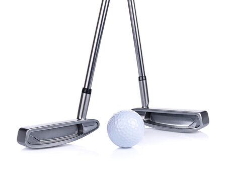 Two golf putters and a ball on white background