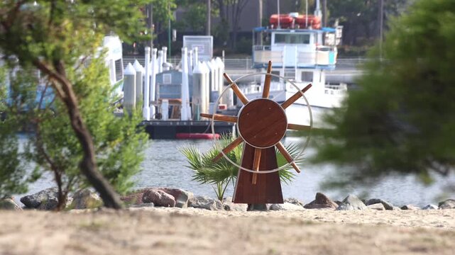 Old Ship Wheel In A Harbor Park