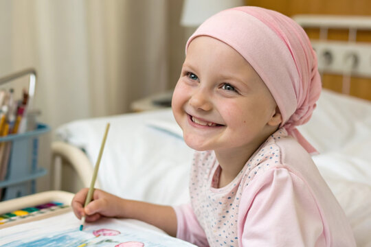 Leukemia girl cancer kid hospital bed smiling portrait drawing in hospital room with headscarf hope during treatment and recovery journey