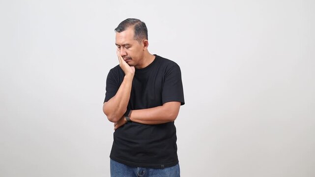 handsome Asian man feeling sad and pensive, isolated on white background