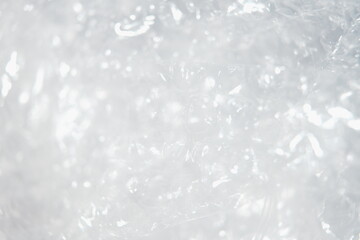 Fototapeta premium Abstract Macro of Translucent Bubble Wrap Texture with Bright Light Reflection for Packaging Protection and Industrial Design Concepts