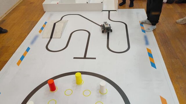 Top view - the robot moves along a marked track on a competitive field for robotics, STEM, programming, engineering training.
