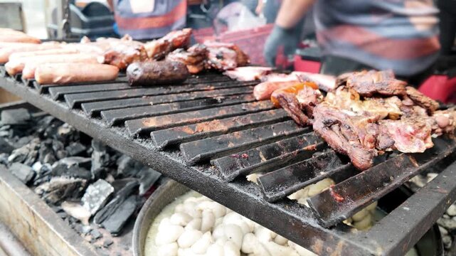 Chef grilling beef steak at barbecue dinner party outside - Close up male hands cooking meat on bbq for family in restaurant backyard - Food and summer activities